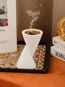 Resin double cone incense burner detail view, white textured craft censer with gold inner bowl.