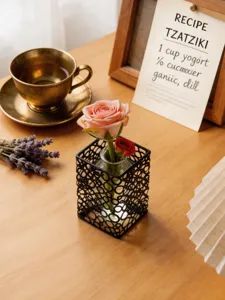 Nahaufnahme des nordischen Eisen Reagenzglas Glasvase mit schönen Rosen auf Holztisch.