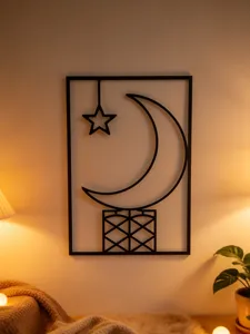 Detailed view of black metal wall art featuring crescent moon and star design for home decor.