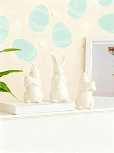 Ceramic Easter bunny figurine set, cute white rabbit holding egg decor for home desk.