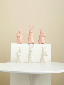 Ceramic easter bunny figurines set, cute bow tie egg holding rabbit decor for spring home table top.
