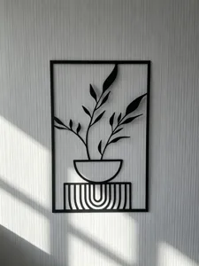 Detailed view of black metal wall art hanging, creative plant motif decor in modern style.