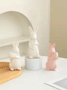 Charming ceramic Easter bunny figurines set with bowties and eggs, cute home desktop decor.