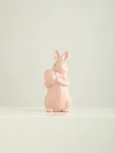 Ceramic Easter bunny figurine with bow tie holding egg, cute home desktop decor ornament.