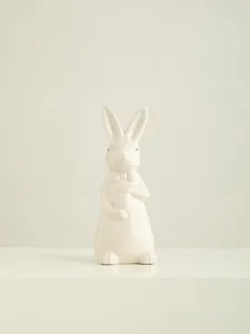 Ceramic Easter bunny figurine with bow tie and egg, cute white rabbit decor for desktop.
