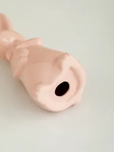 Ceramic rabbit detail shot showing smooth pink finish and base craft design for decor.