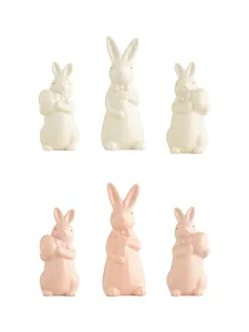 Ceramic Easter bunny figurine set, cute bow-tie and egg design, desktop decor details.