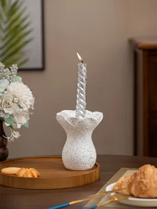 Detailed view of white resin flower candle holder showcasing its unique speckled texture design.