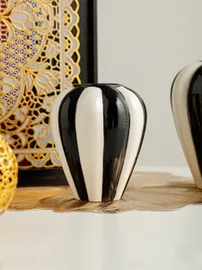Nordic simple glossy black white ceramic vase, detail shot of decorative vase for home decor.
