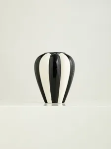 Black and white striped ceramic vase detail view, Nordic modern home decor accent piece.