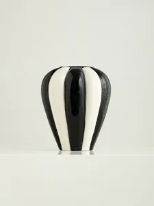 Close-up of the elegant black and white striped ceramic vase showing its glossy finish and details.