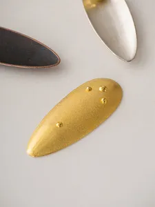 Close-up detail of the creative willow leaf metal incense holder with mini beads texture.