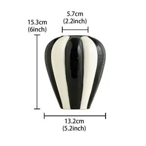 Minimalist black and white striped ceramic vase for modern home decor and floral display.