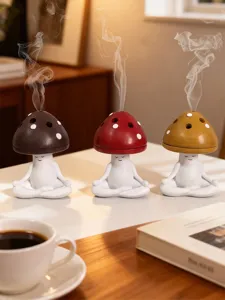 Cute meditating mushroom incense burner detail view, ceramic aromatherapy stove for home decor.