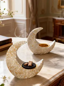 Detail view of Arabic crescent resin incense burner with golden inner tray and smoky aroma.