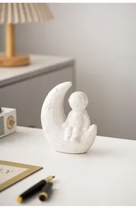 Modern creative astronaut moon ceramic ornament for home desktop and bookshelf decoration.