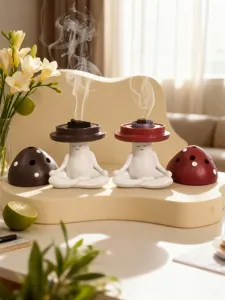 Detailed shot of cute meditating mushroom incense burners with smoke effect on creative platform.