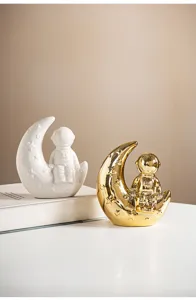 Detailed view of creative astronaut and moon ceramic ornaments, ideal for modern home decor.