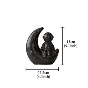 Details of the creative black ceramic astronaut and moon ornament, perfect for home decor.