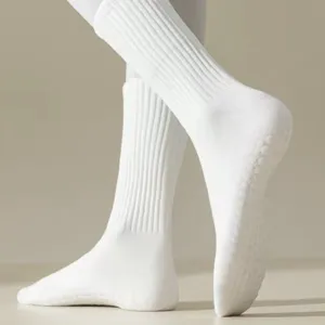 Detail of white grip yoga socks with anti-slip silicone dots for pilates and fitness workouts