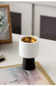 Modern minimalist geometric incense burner detail, elegant white and black design for home decor.