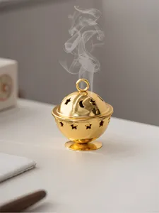 Golden mini metal incense burner with hollow star and moon patterns for tabletop home decoration.