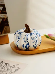 Blue and white ceramic pumpkin decor, elegant autumn table ornament for home.