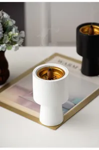 Modern minimalist white ceramic and metal incense burner cone holder for home decor and aromatherapy.