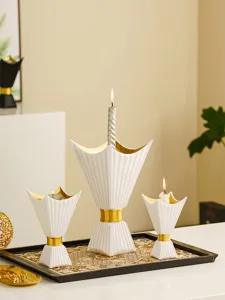 Detail view of Middle Eastern style white and gold candle holders set on a decorative tray.