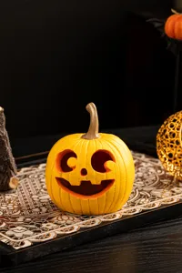 Halloween yellow carved pumpkin resin ornament detail showing festive tabletop decor texture and design.