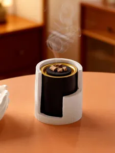 Modern Middle Eastern incense burner with bark texture white shell and black gold interior pot.
