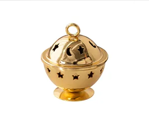 Golden metal mini censer close-up featuring star and moon hollow design for desktop decor.