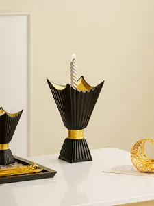 Exquisite black and gold chalice candle holder detail, elegant Middle Eastern decor.