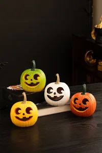 Detail view of colorful resin Halloween pumpkin ornaments set, creative home desktop harvest decor.