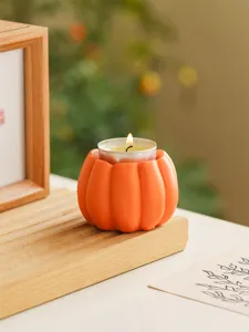 Detailed close-up of resin pumpkin tea light candle holder for autumn Halloween decor