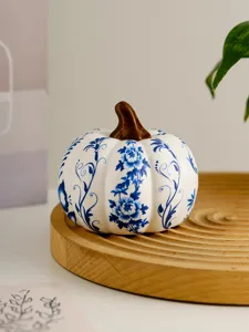 Blue and white ceramic pumpkin figurine, exquisite floral pattern, elegant home decor detail.