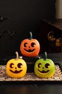 Detailed view of colorful Halloween resin pumpkin ornaments for spooky home desktop decor.