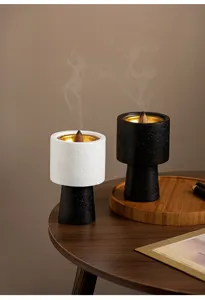Modern minimalist incense burner detail view, creative cone censer with smoke for home decor.