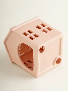 Pink ceramic house candle holder detail, modern minimalist hollow design for home table decor.