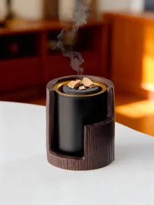 Detailed close-up of modern Middle Eastern bark-texture incense burner with smoking bakhoor.