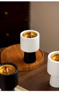 Modern minimalist ceramic incense burner with gold interior, creative home decor aroma diffuser.