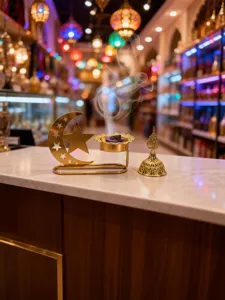 Golden hollow star moon incense burner, Middle Eastern Arabian style home decor aromatherapy setup.