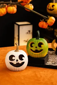 Resin Halloween pumpkin decor, carved smiling face desktop ornament for holiday party display.