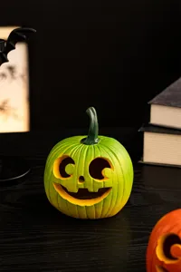 Detailed view of the green resin Halloween pumpkin decoration, perfect for festive desktop display.