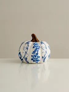 Ceramic blue and white porcelain pumpkin ornament detail shot, exquisite floral decor.