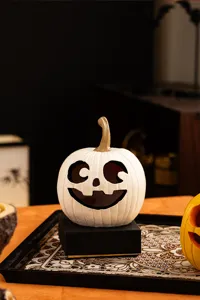 Detailed view of white resin Halloween pumpkin figurine decor, perfect for festive tabletop styling.