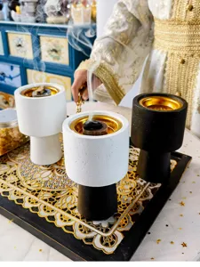 Detailed view of modern concrete incense burners with gold metal inserts for home decor fragrance.