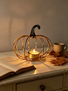 Gold iron pumpkin candle holder for Halloween, decorative metal tea light holder for home decor.