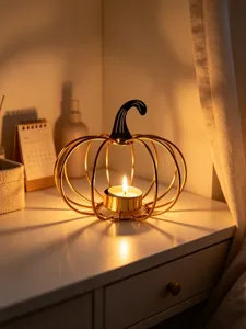 Metal pumpkin tea light candle holder for Halloween party, romantic home table decor piece.