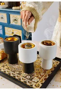 Detail view of Arabic incense burner set with modern minimalist design and gold inner bowl.
